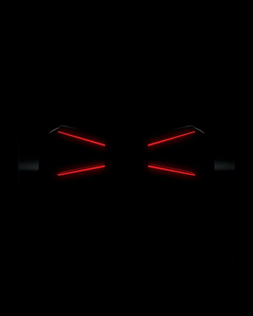 Red neon light beams forming a geometric bow tie shape against a dark, minimalist black background.