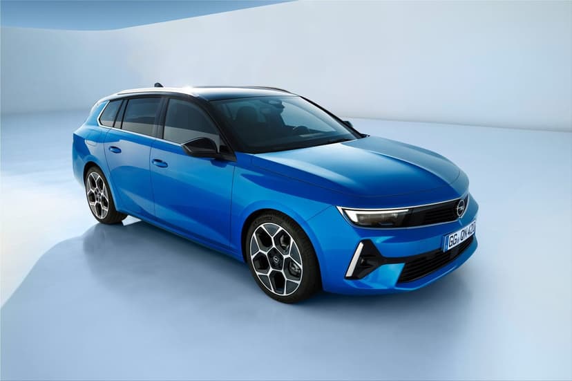 Blue Opel Astra Sports Tourer station wagon parked in a minimalist light blue studio with soft lighting.