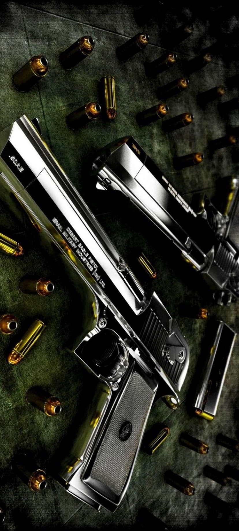 Chrome Desert Eagle pistols and brass ammunition scattered across a dark textured surface in an overhead view.