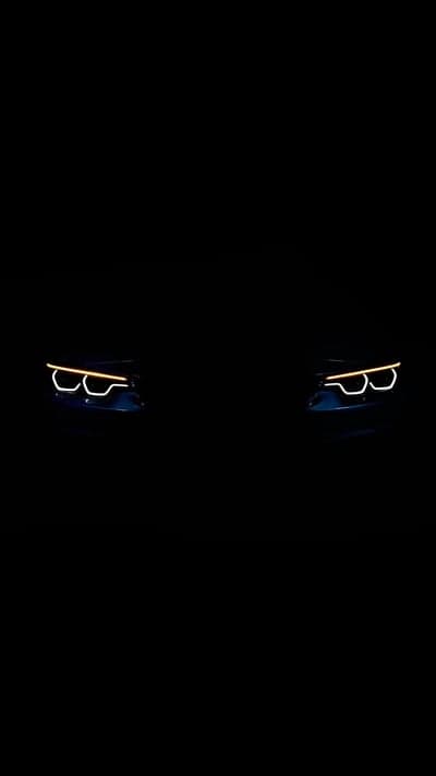 Glowing Amber LED Car Headlights Dark Mobile Wallpaper