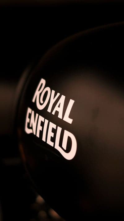 Royal Enfield logo on a dark matte motorcycle tank