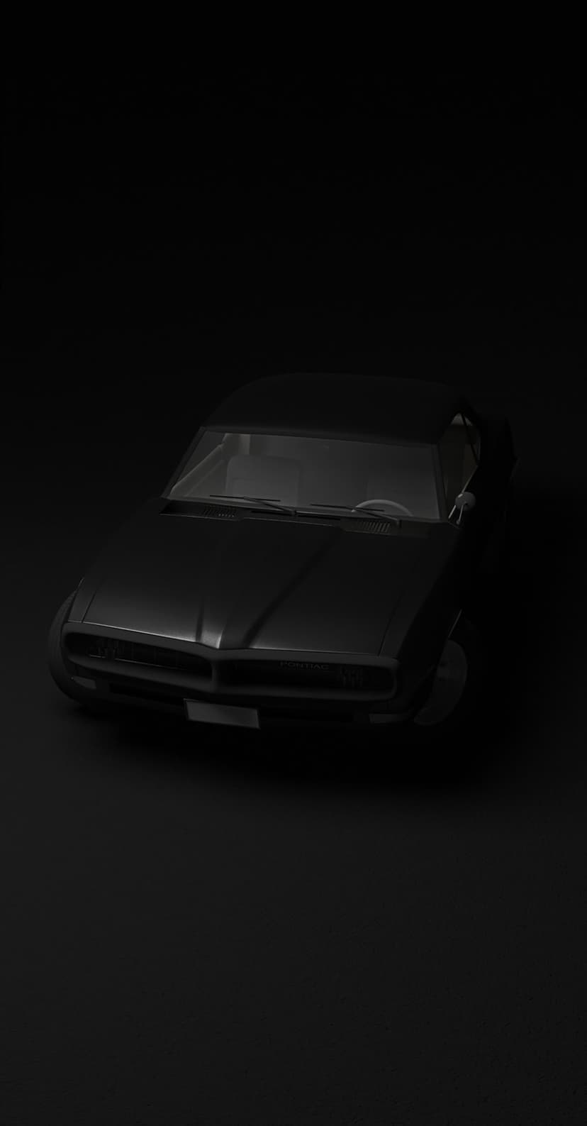 Black sports car front view with circular headlights and a grille visible against a solid dark background.