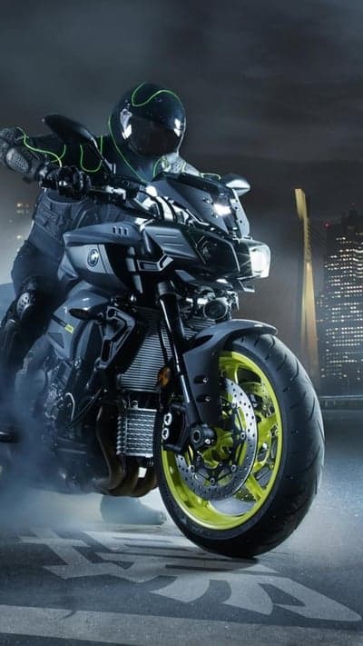 Rider in Neon Gear on Sportbike with Cityscape