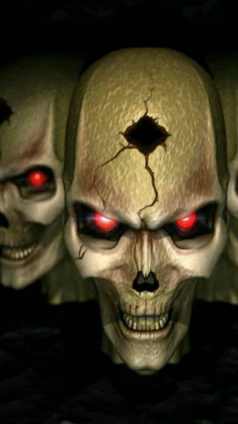Three skulls with glowing red eyes and a cracked forehead staring forward through deep atmospheric shadows.