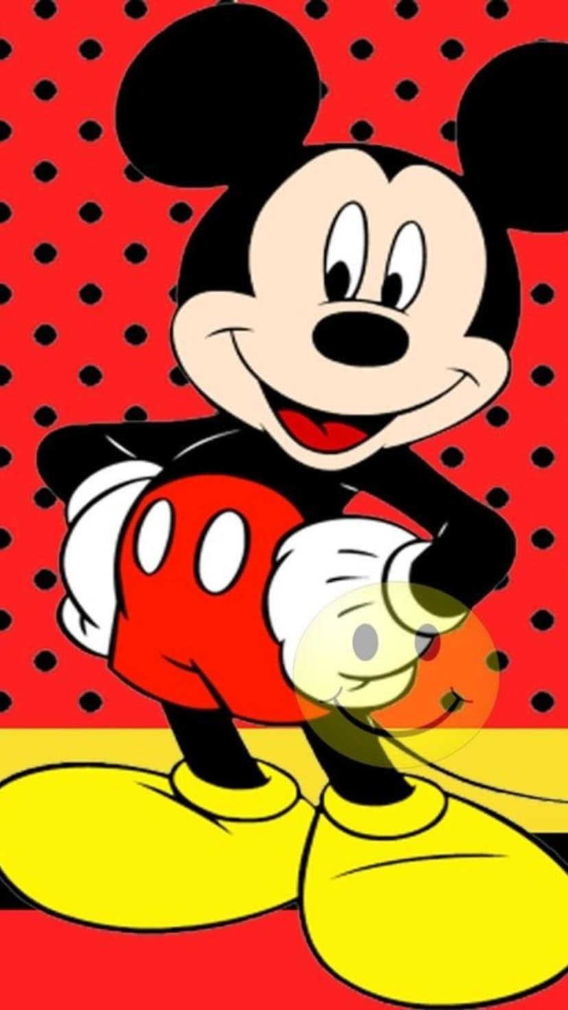 Mickey Mouse with a cheerful expression and red shorts against a red background with black polka dots.