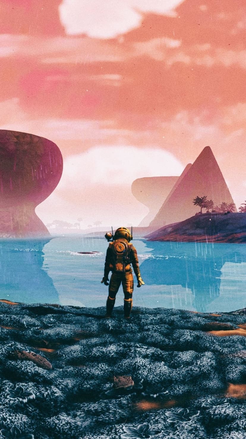 Astronaut in yellow suit stands on a rocky shore looking at turquoise water and pink alien sky with mountains.