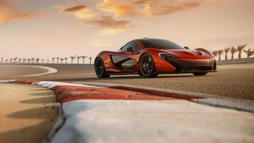 Red McLaren P1 on a race track at sunset with palm trees and a golden sky in the distance.