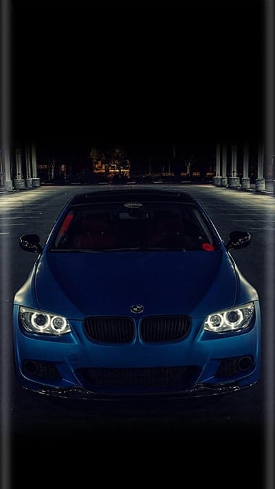 Blue BMW Coupe Headlights and Grille at Night