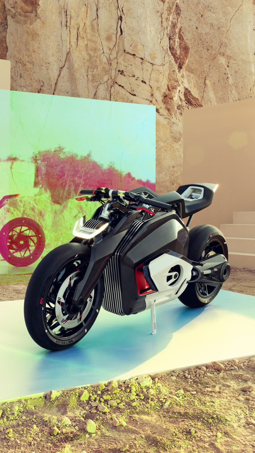 Futuristic black motorcycle with red accents parked on a glowing base amidst rugged desert rock formations.