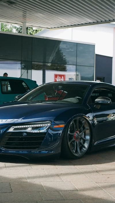 Blue Audi R8 Supercar with Red Accent Rims Phone Wallpaper