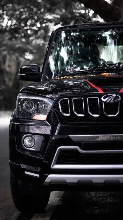 Black Mahindra Scorpio parked outdoors in moody lighting