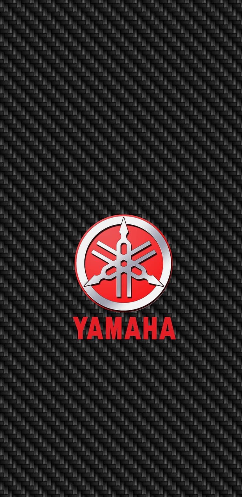 Yamaha tuning fork emblem on a red circle centered on a black carbon fiber weave with red lettering below.