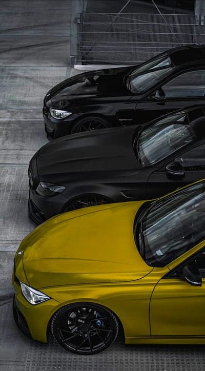 Three BMWs in a row: yellow and black