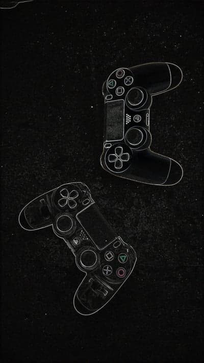 Two Game Controllers on Dark Textured Background