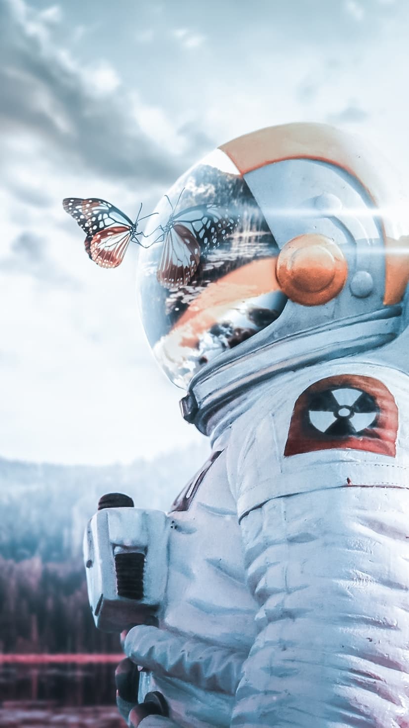 Butterfly perched on an astronaut's helmet visor reflecting a distant sky and mountains in high detail.