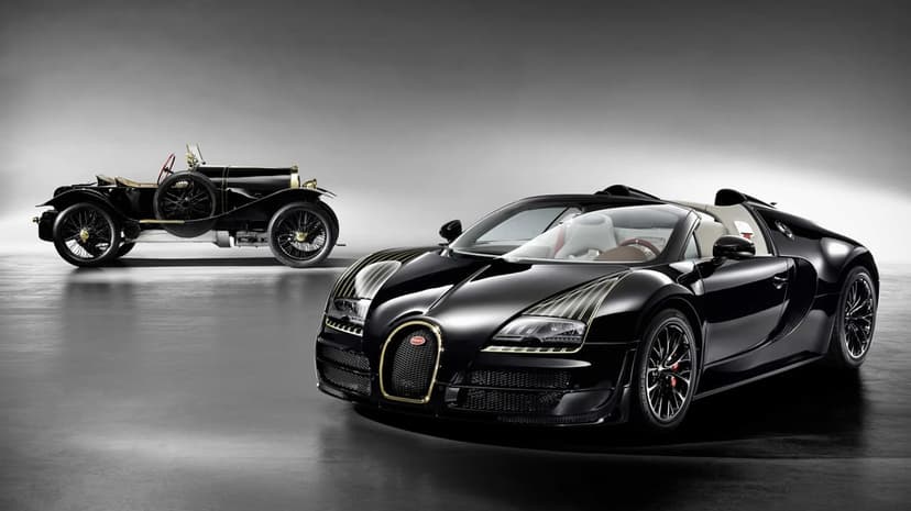 Modern black Bugatti hypercar with gold accents and a vintage race car in a minimalist grey studio.