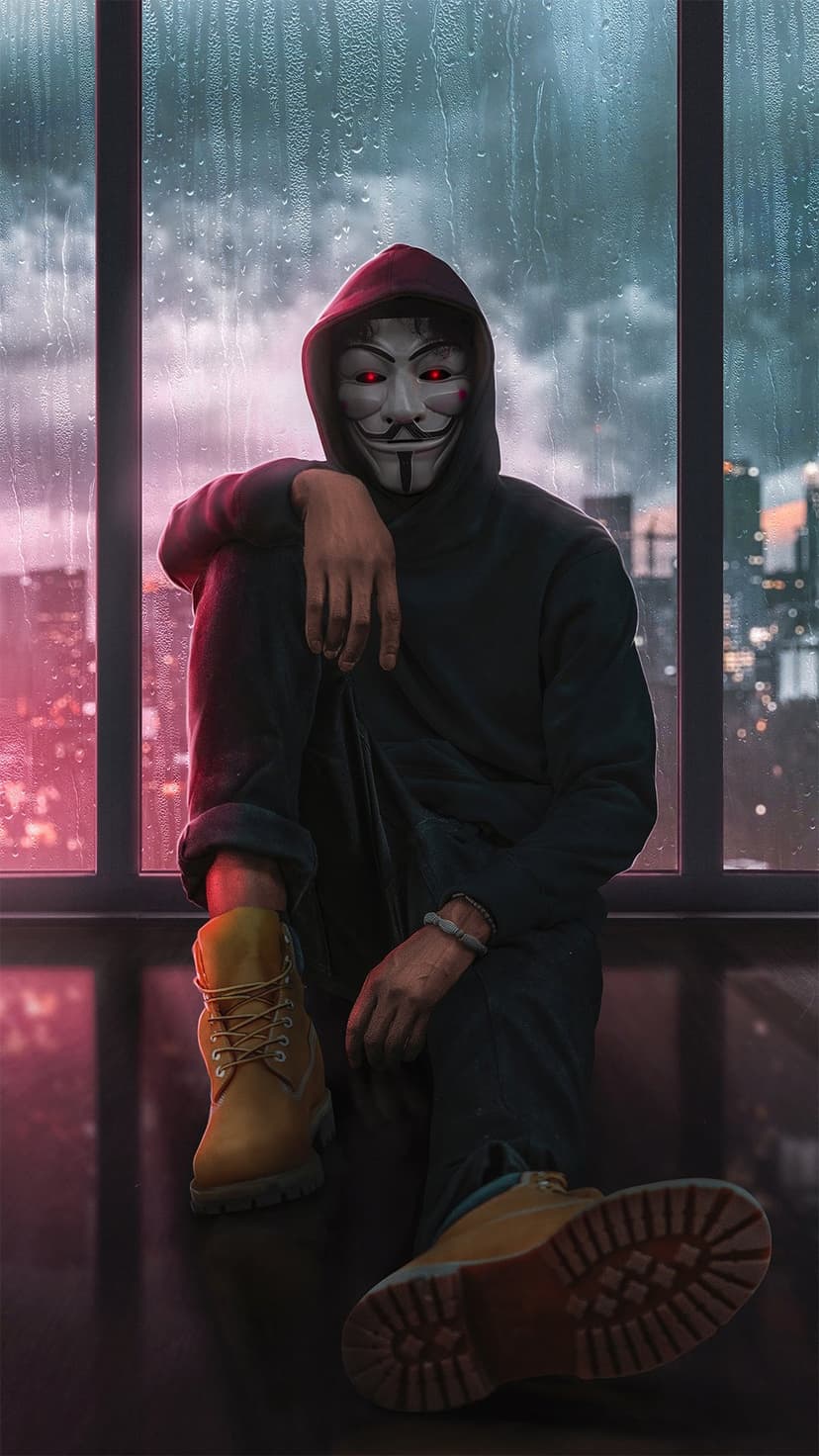 Masked figure with glowing red eyes in a dark hoodie sits by a rain-streaked window overlooking city lights.