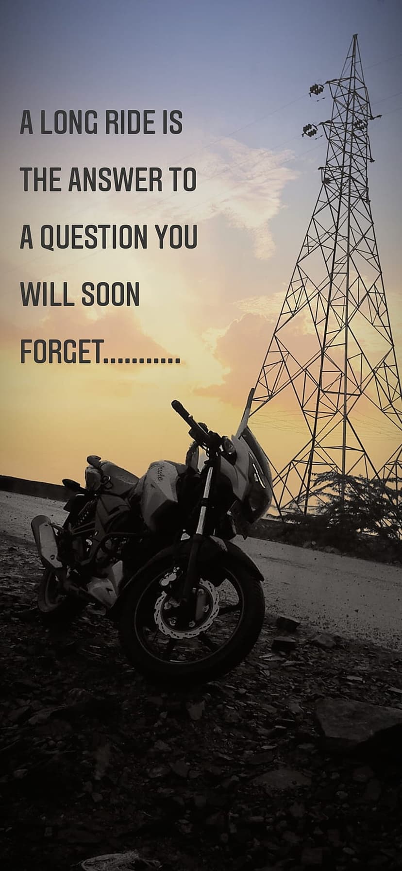 Motorcycle parked beside an electric pylon under a fiery orange sunset with an inspirational text overlay.
