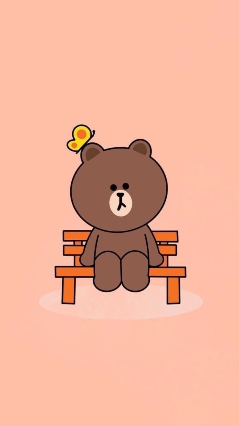Plump brown bear sits on an orange bench with a tiny yellow butterfly resting on its head against a peach backdrop.