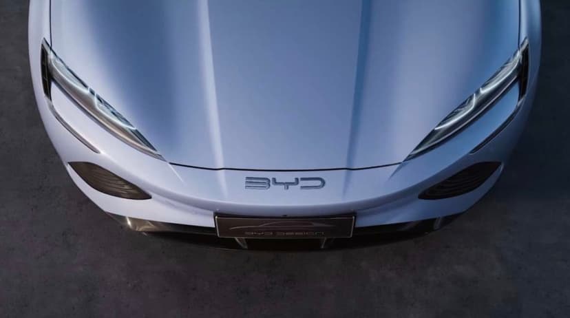 Silver BYD electric car front hood and LED headlights seen from above with clean metallic textures and soft light.