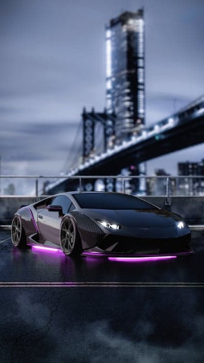 Black Lamborghini with purple underglow in a city