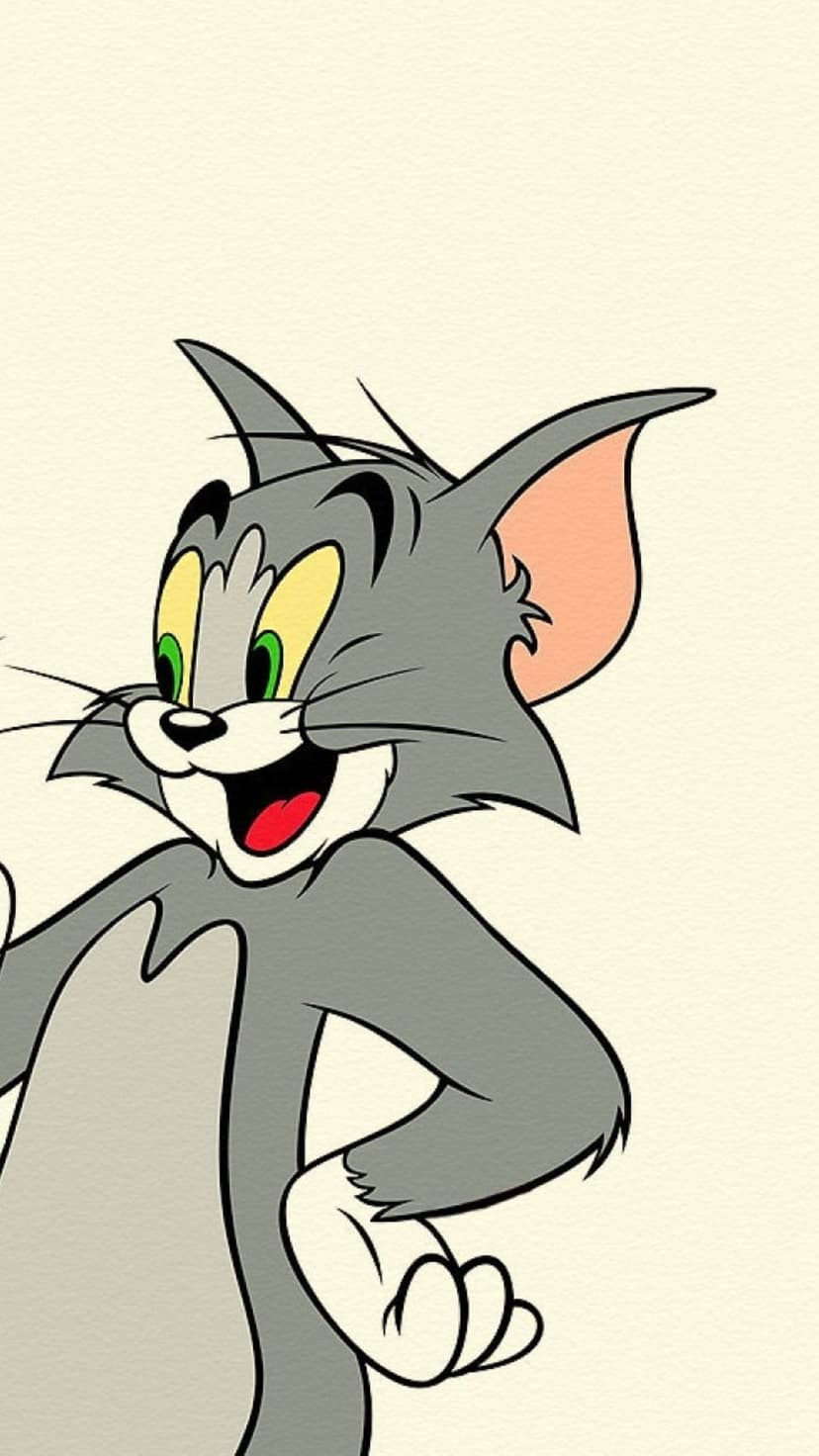 Tom Cat smiles with bright green eyes and a wide grin while standing against a light cream textured background.