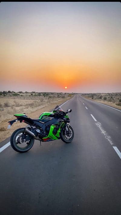 Motorcycle on desert highway at sunset