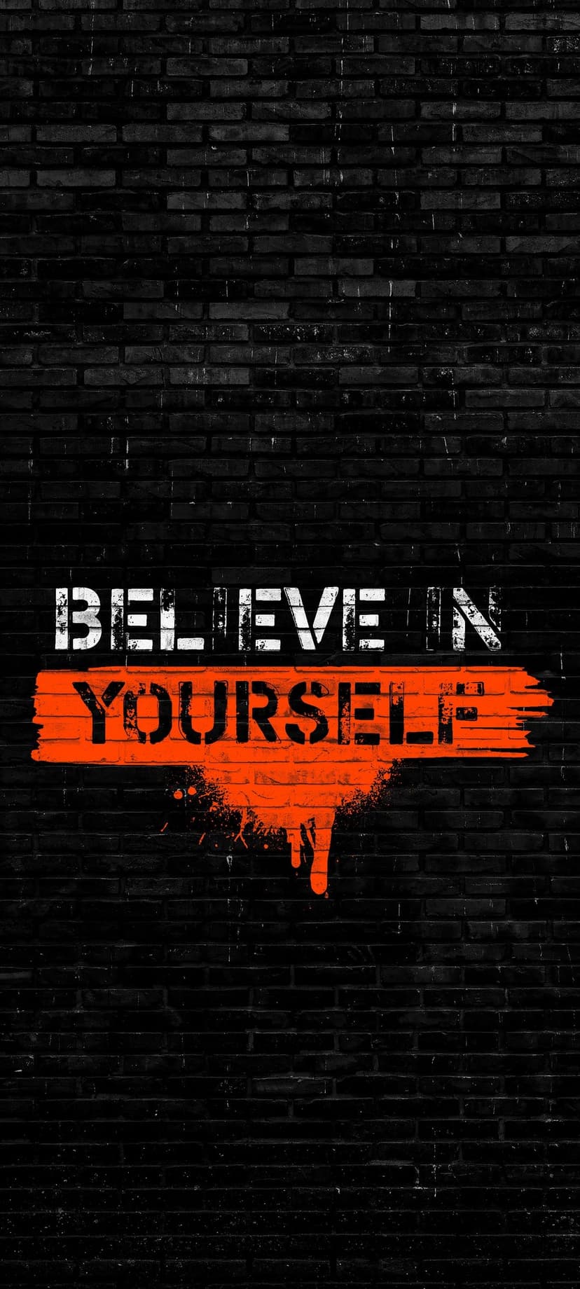 Believe In Yourself spray-painted in white and orange on a dark textured brick wall with dripping paint streaks.
