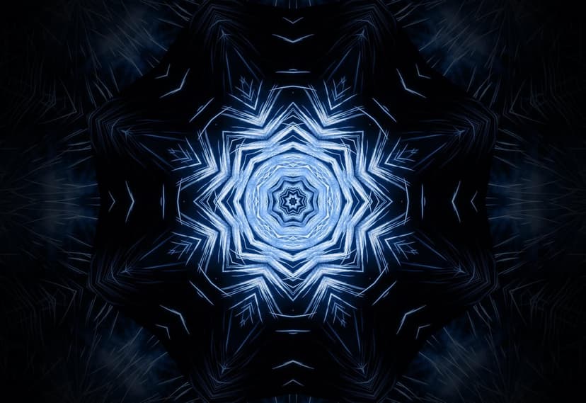 Glowing blue starburst mandala with symmetrical geometric patterns and sharp fractal details on a dark background.