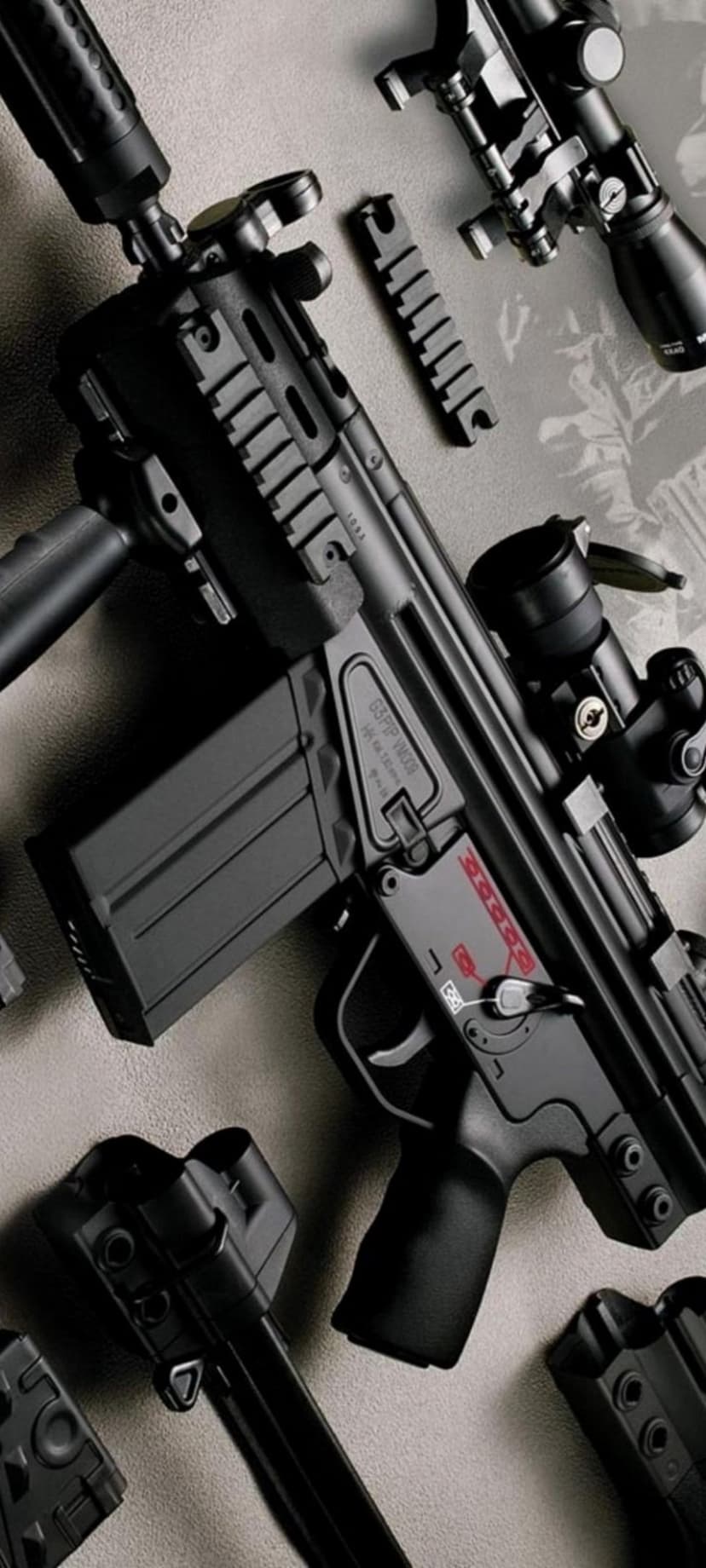 HK G36 rifle with optic handle and accessory rails displays a matte black finish in a vertical close-up.