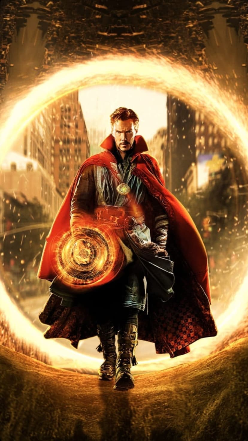 Doctor Strange stands in a red cape while opening a circular orange magic portal on a New York City street.
