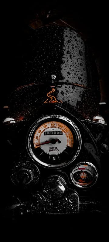 Rain-Drenched Royal Enfield Motorcycle Speedometer Close-Up