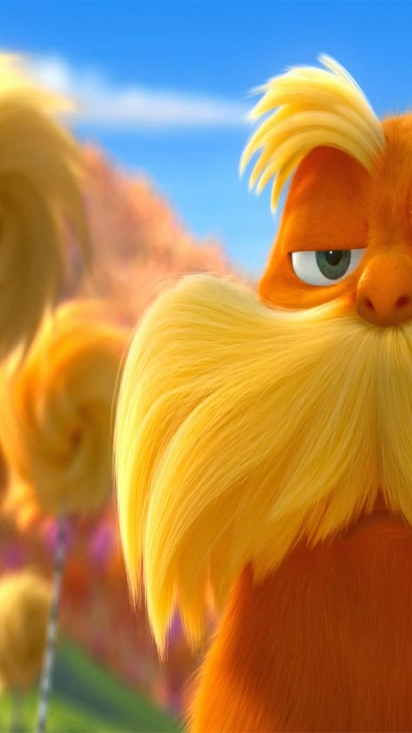 The Lorax with vibrant orange fur, bushy yellow mustache, and a green eye against a soft blue backdrop.