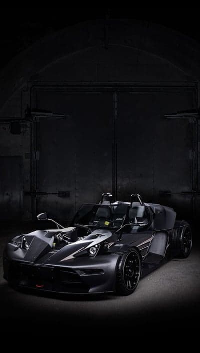Sleek Black Sports Car in Dark Industrial Garage