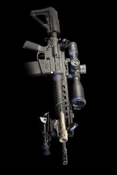 Tactical AR-15 rifle with scope, bipod, and light