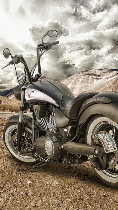 Victory motorcycle on rugged terrain with dramatic sky