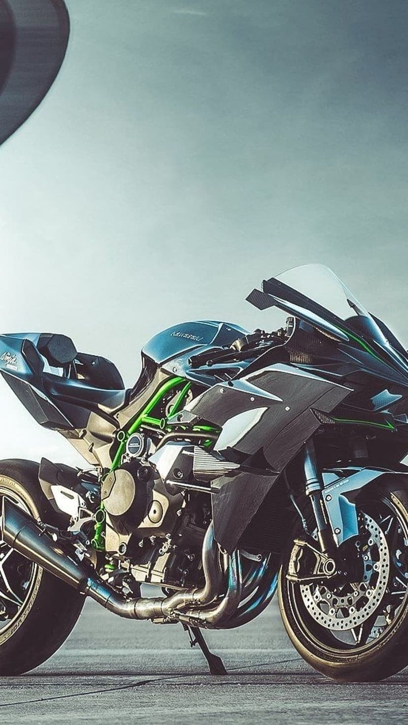 Kawasaki Ninja H2 motorcycle with a green trellis frame, black fairings, and visible engine parts outdoors.