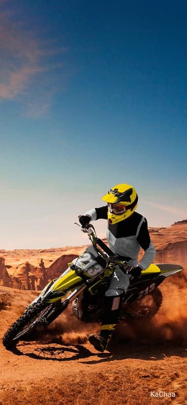 Motocross Rider Speeds Through Desert Canyon