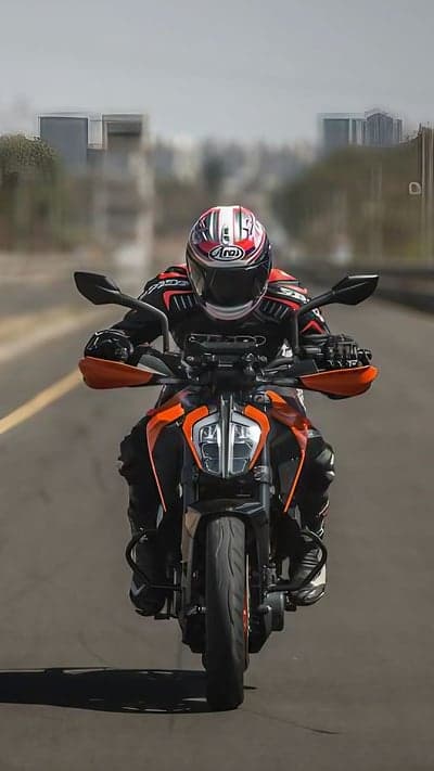 Motorcyclist in Arai Helmet Rides Orange KTM Motorcycle