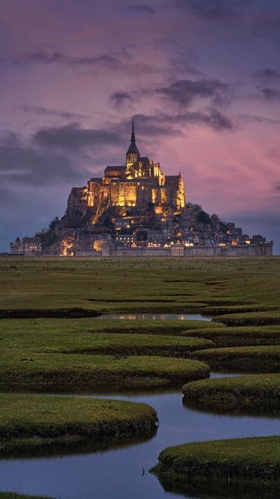 Mont Saint-Michel by Night- Illuminated Abbey Over Winding Waterways
