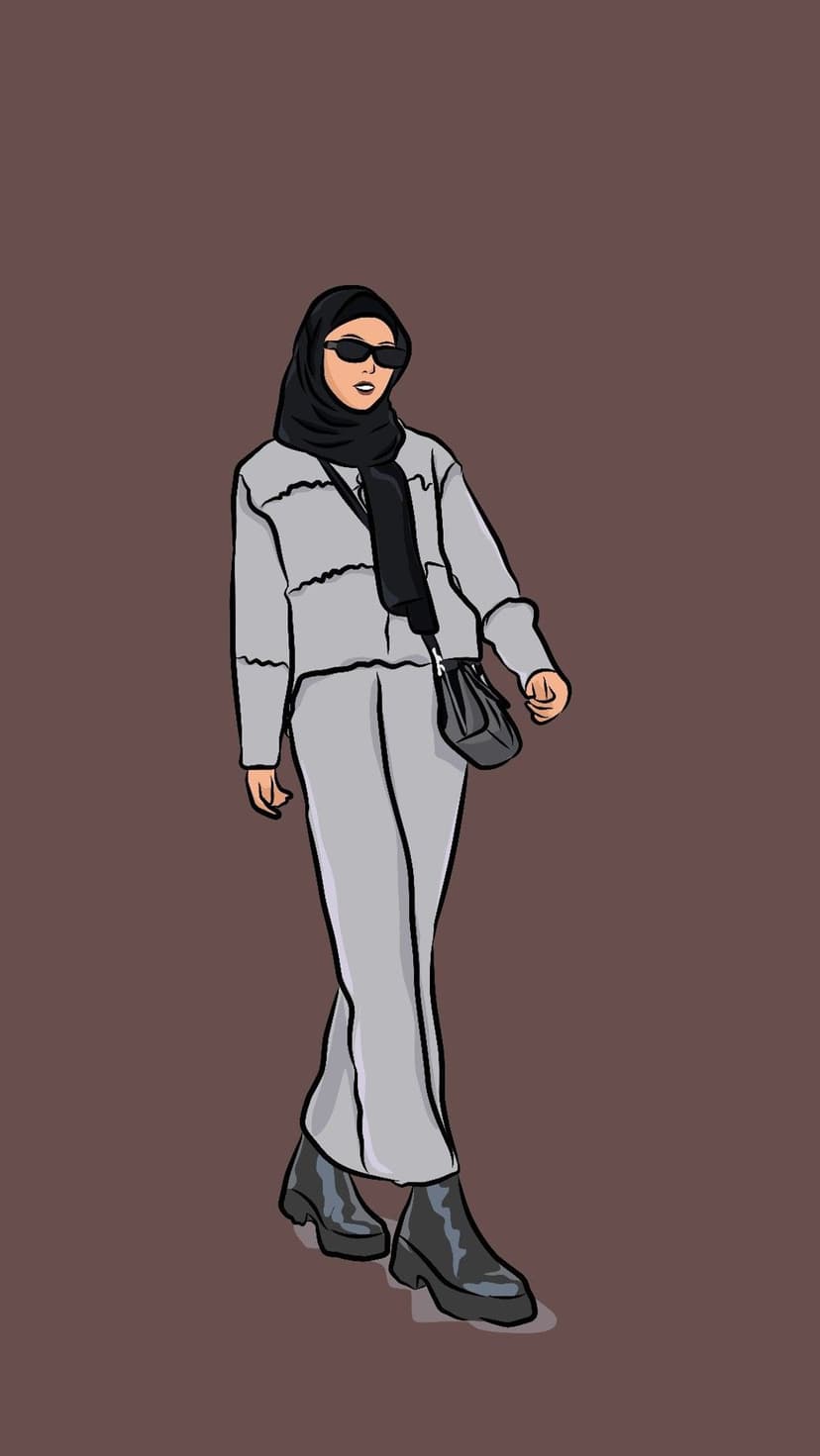 Woman in a black hijab, grey outfit, and sunglasses stands against a brown background with a crossbody bag.