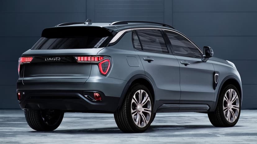 Matte grey Lynk & Co SUV shown from a rear three-quarter view with glowing red LED taillights in a studio.