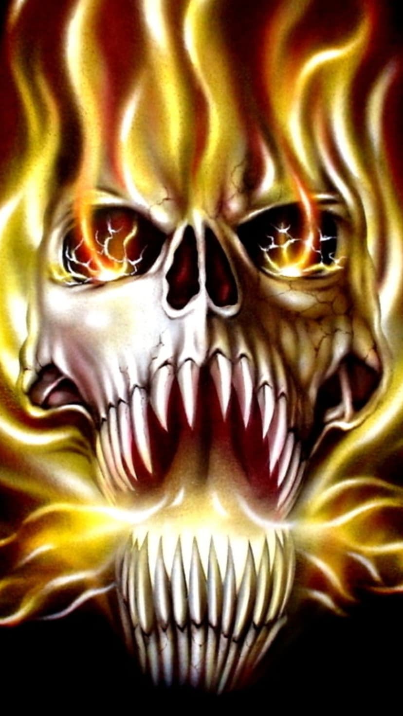 Flaming skull with glowing orange eyes and sharp teeth surrounded by dense clouds of fire and embers.