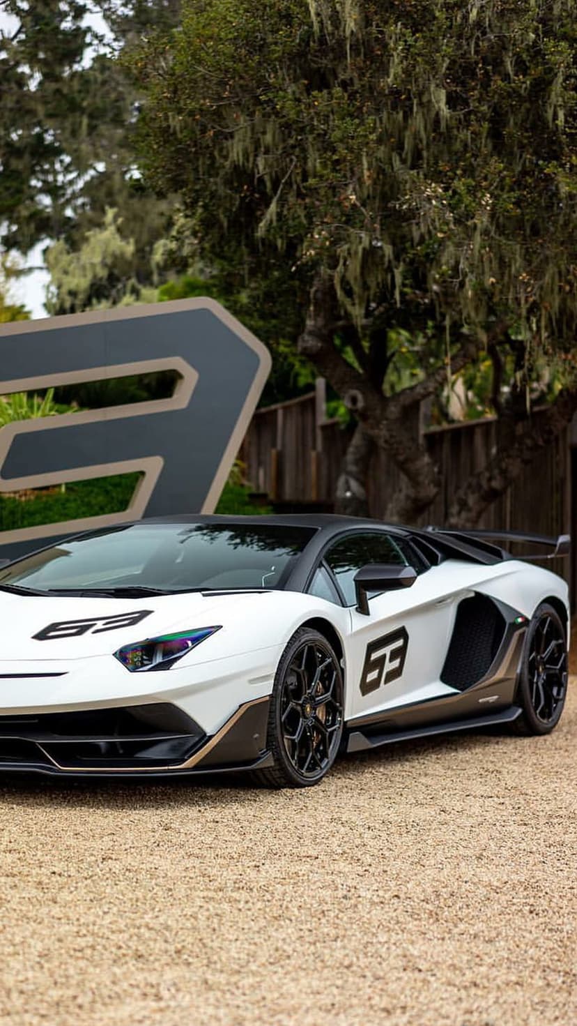Lamborghini Aventador SVJ 63 in white parked on gravel with black accents and a stylized number three behind it.