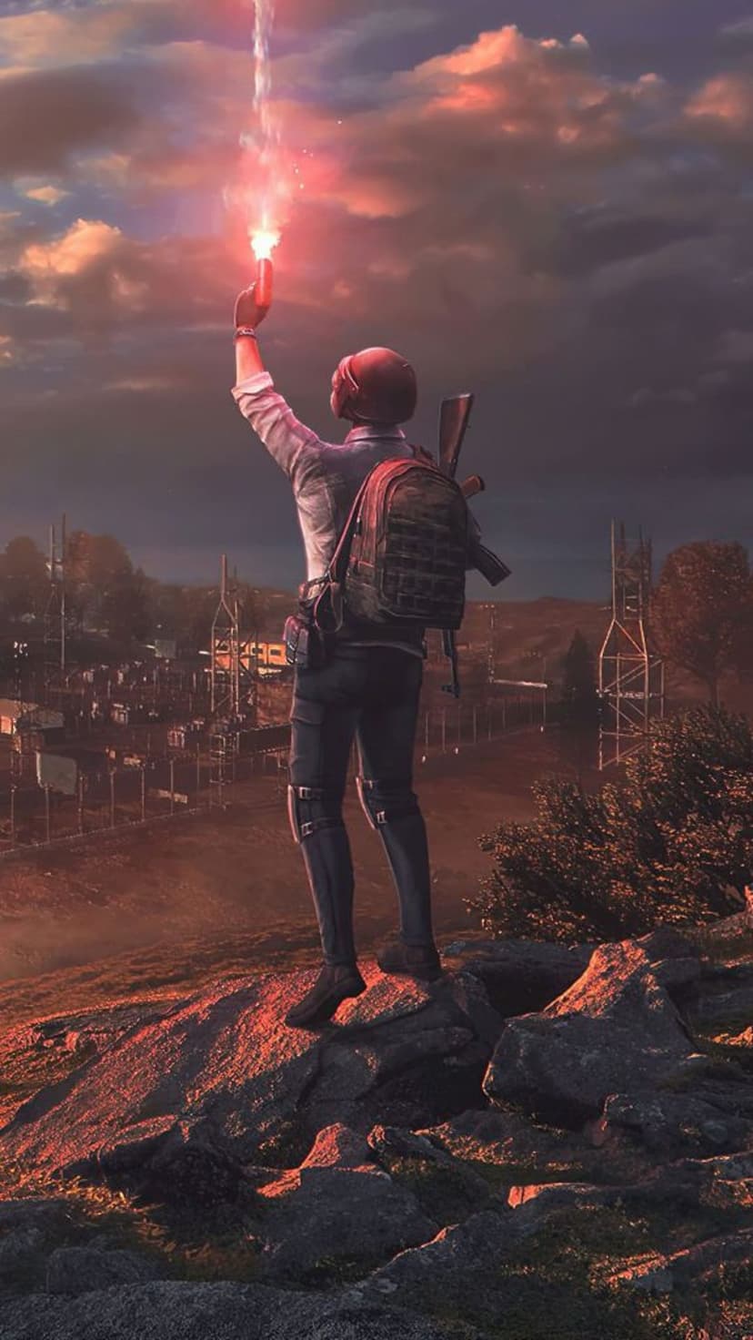 Tactical soldier firing a red flare gun from a rocky cliff above a sprawling industrial city during sunset.