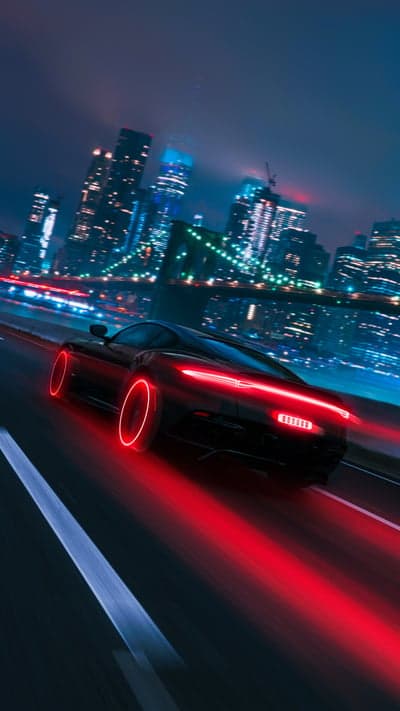 Futuristic Black Sports Car Speeds Through Neon Cityscape