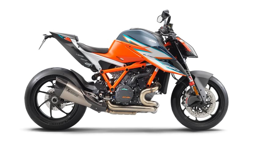 KTM 1290 Super Duke R Evo profile featuring orange trellis frame and Akrapovic exhaust on a white background.