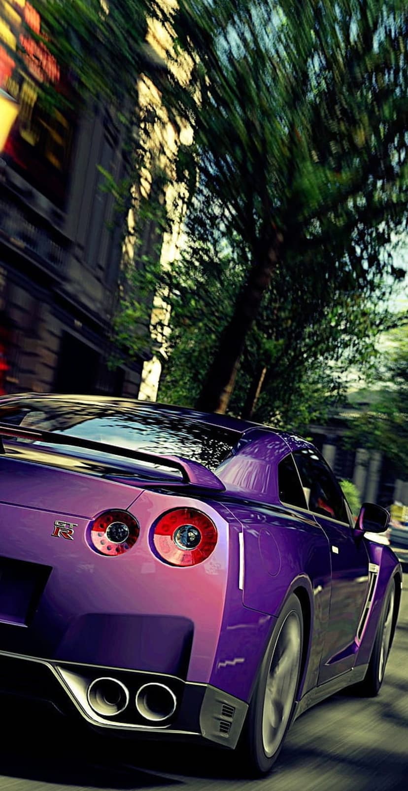 Nissan GT-R rear view with glowing red taillights and quad exhausts on a blurred urban street with green trees.