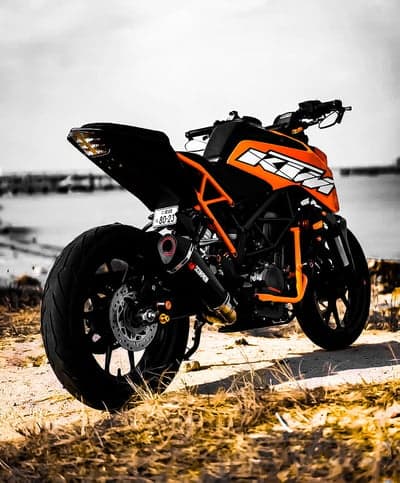 Dramatic KTM Motorcycle Beach View Phone Background