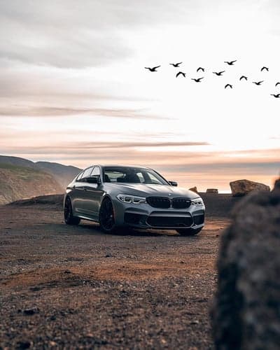 Luxury BMW M5 Sunset Coastal Cliff Phone Backdrop